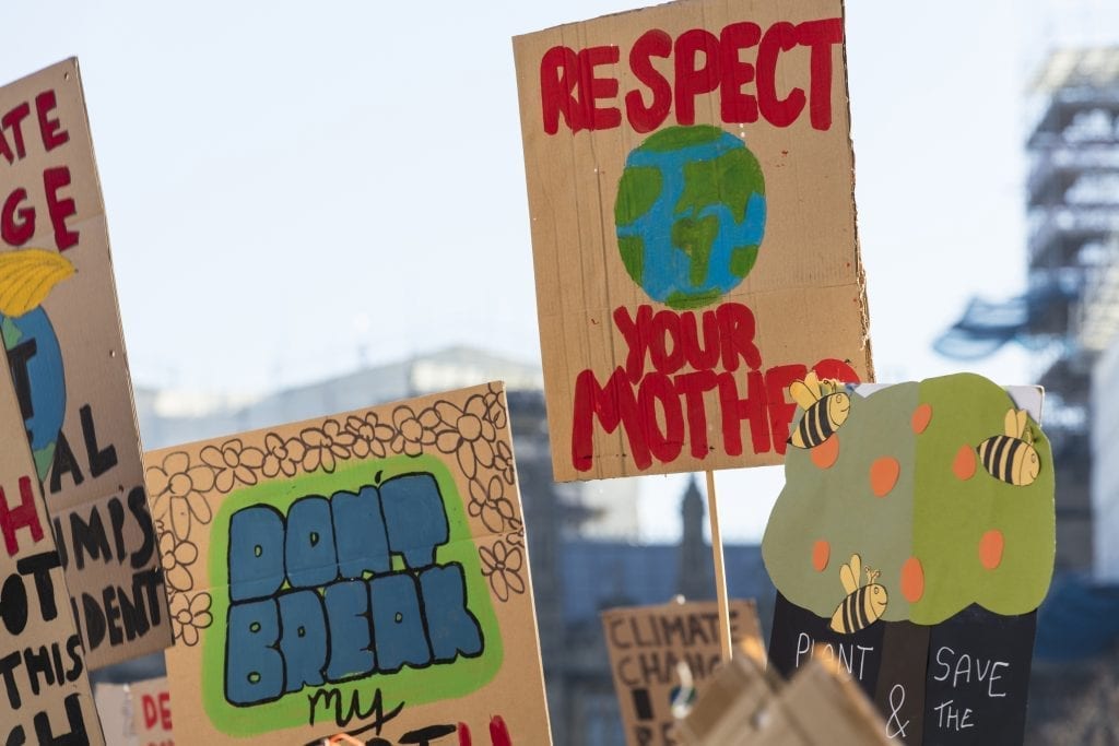 Protestors holding climate change banners at a protest